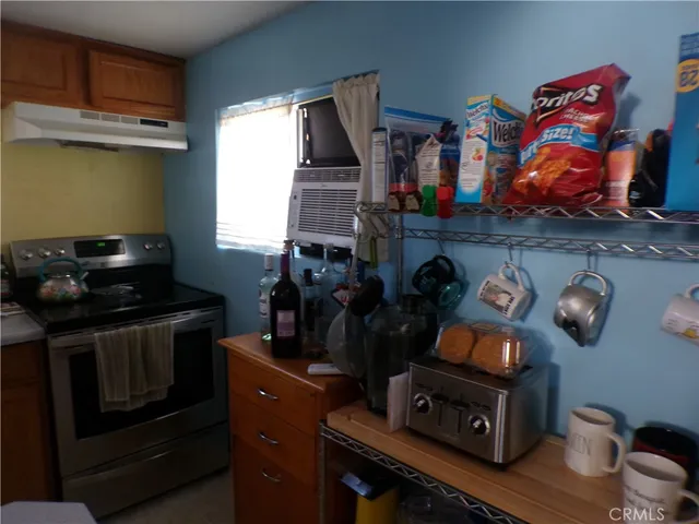 a room that has painting on the wall and a dresser