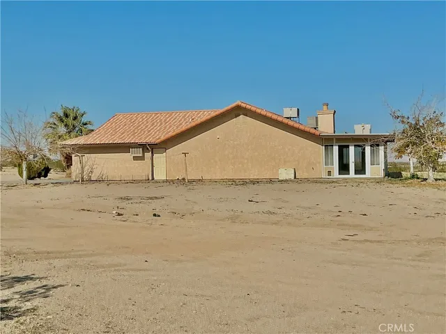 a view of a house with a wooden fence
