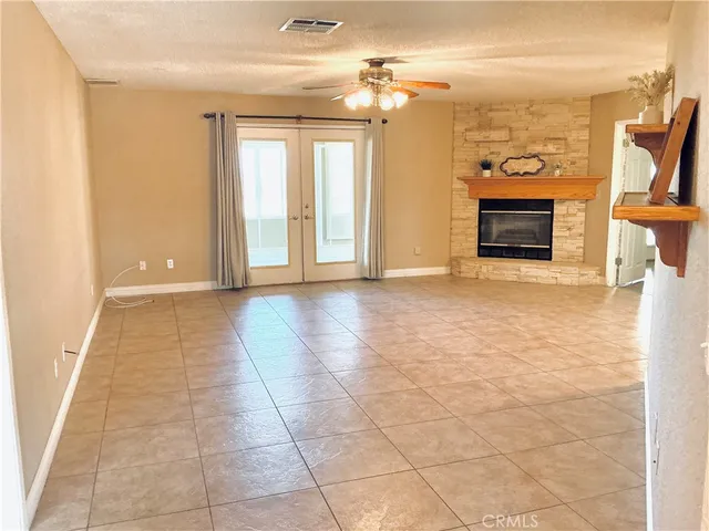 a view of a livingroom with a fireplace and a window