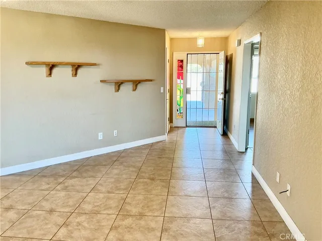 a view of a hallway with wooden shelves