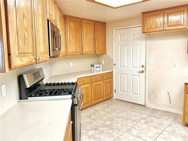 a kitchen with stainless steel appliances a stove a sink and a microwave