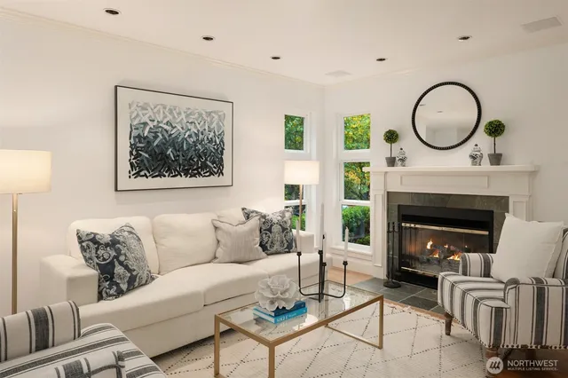 a living room with furniture a window and a fireplace