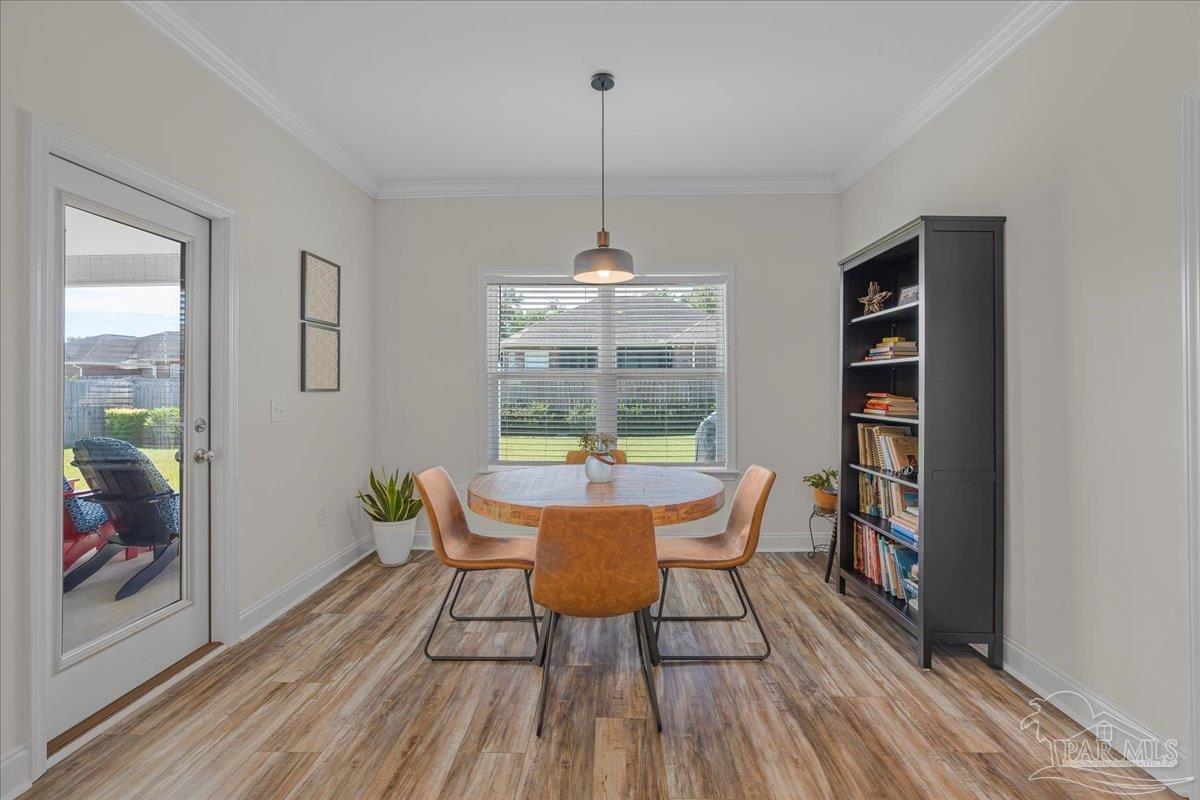 441 Broadleaf Circle Cantonment, FL 32533 - Photo 17 of 42 a dining room with furniture wooden floor and window