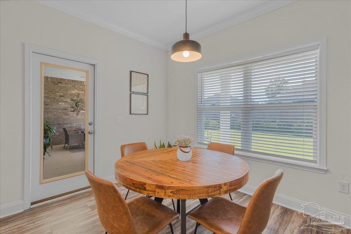 441 Broadleaf Circle Cantonment, FL 32533 - Photo 18 of 42 a view of a dining room with furniture and wooden floor