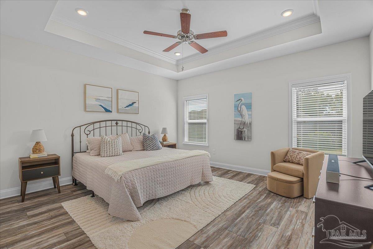 441 Broadleaf Circle Cantonment, FL 32533 - Photo 19 of 42 a bedroom with a large bed and a chandelier