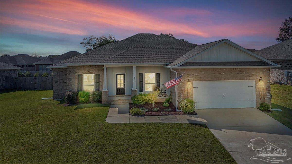 441 Broadleaf Circle Cantonment, FL 32533 - Photo 2 of 42 a front view of a house with garden