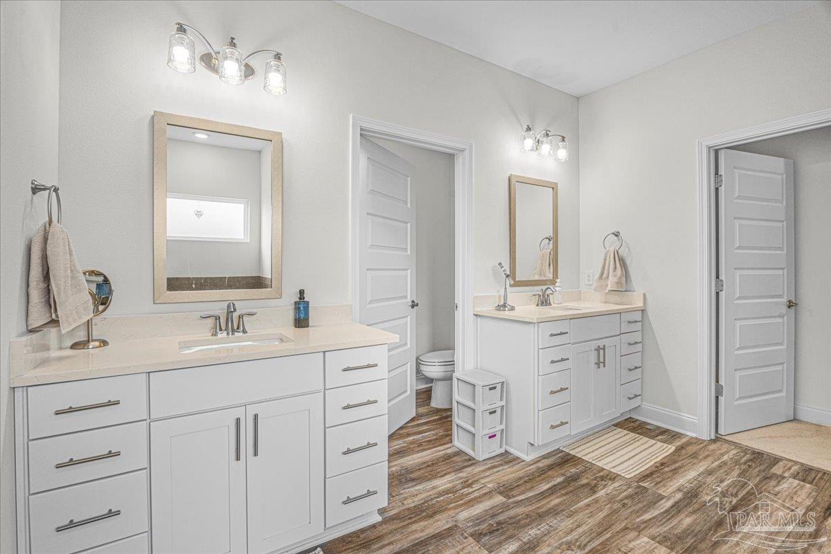 441 Broadleaf Circle Cantonment, FL 32533 - Photo 21 of 42 a bathroom with double vanity sink a mirror and vanity