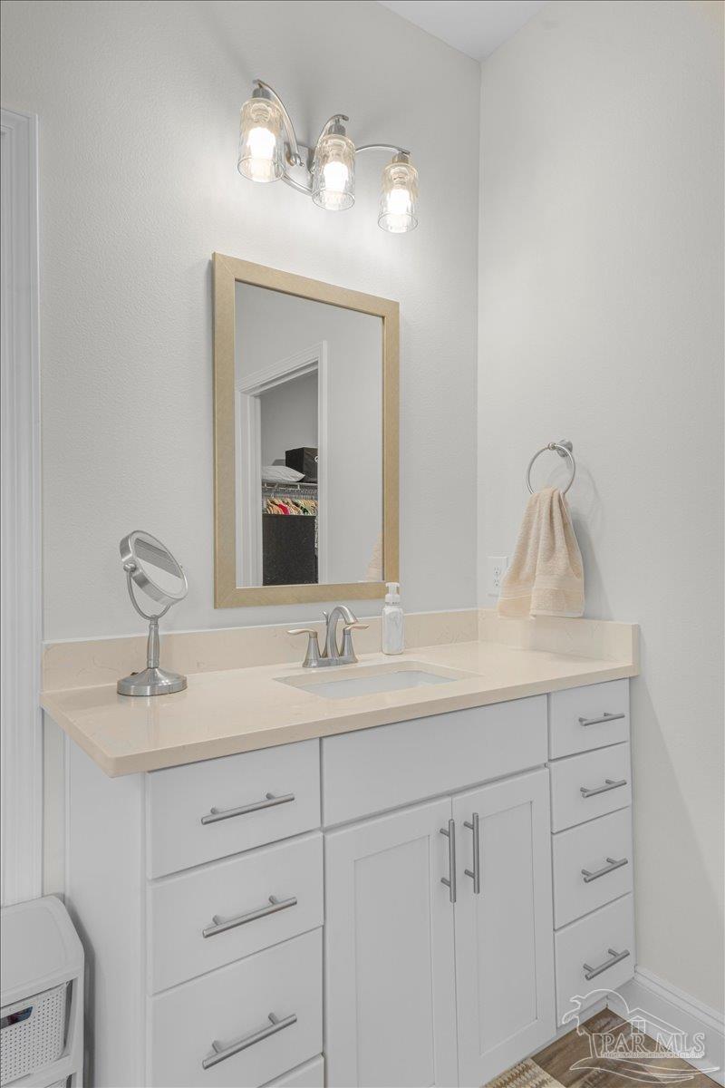 441 Broadleaf Circle Cantonment, FL 32533 - Photo 22 of 42 a bathroom with a sink vanity and mirror