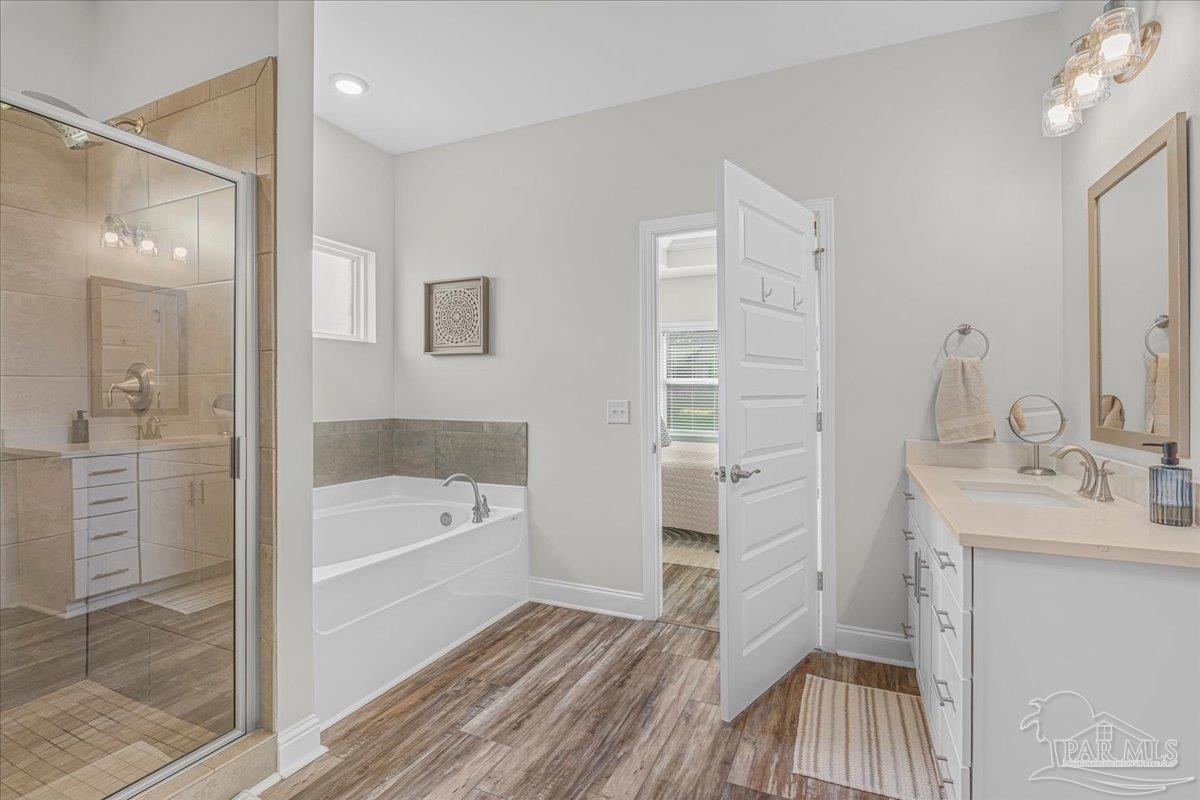 441 Broadleaf Circle Cantonment, FL 32533 - Photo 23 of 42 a bathroom with a sink a mirror and a bathtub