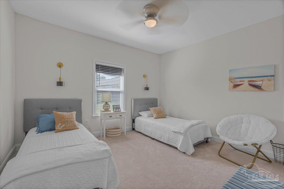 441 Broadleaf Circle Cantonment, FL 32533 - Photo 25 of 42 a bedroom with two beds and a chair