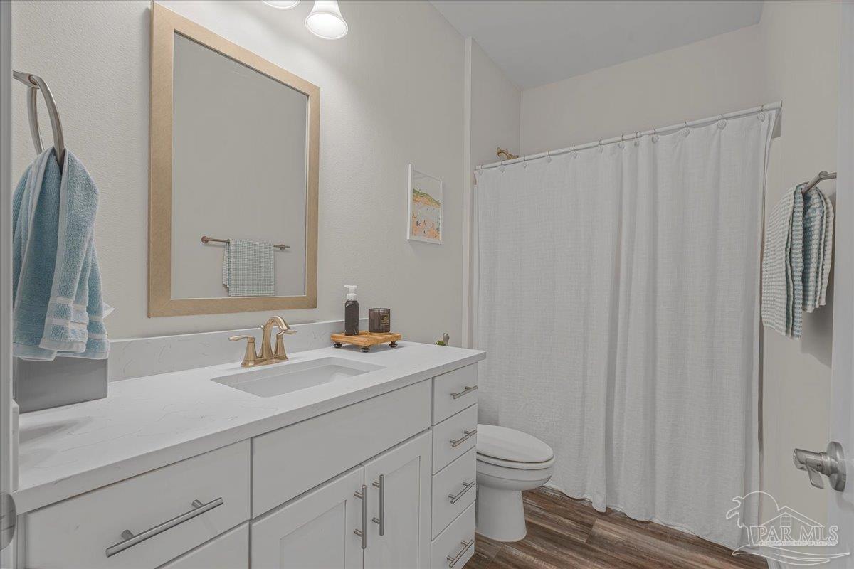 441 Broadleaf Circle Cantonment, FL 32533 - Photo 27 of 42 a bathroom with a toilet a sink and a mirror