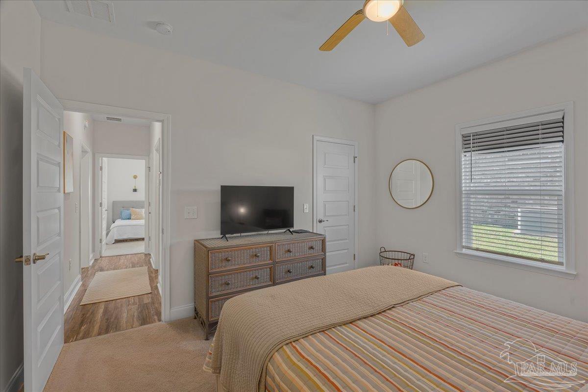 441 Broadleaf Circle Cantonment, FL 32533 - Photo 29 of 42 a bedroom with a bed and a flat tv screen on dresser