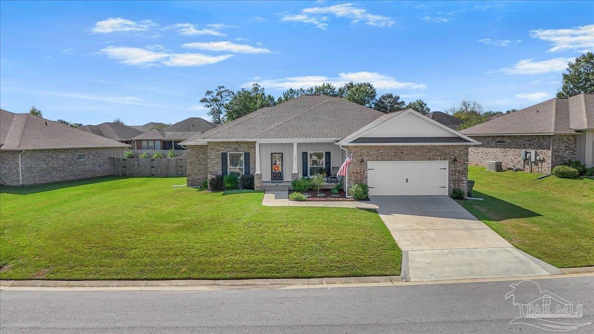 441 Broadleaf Circle Cantonment, FL 32533 - Photo 3 of 42 a front view of a house with a yard