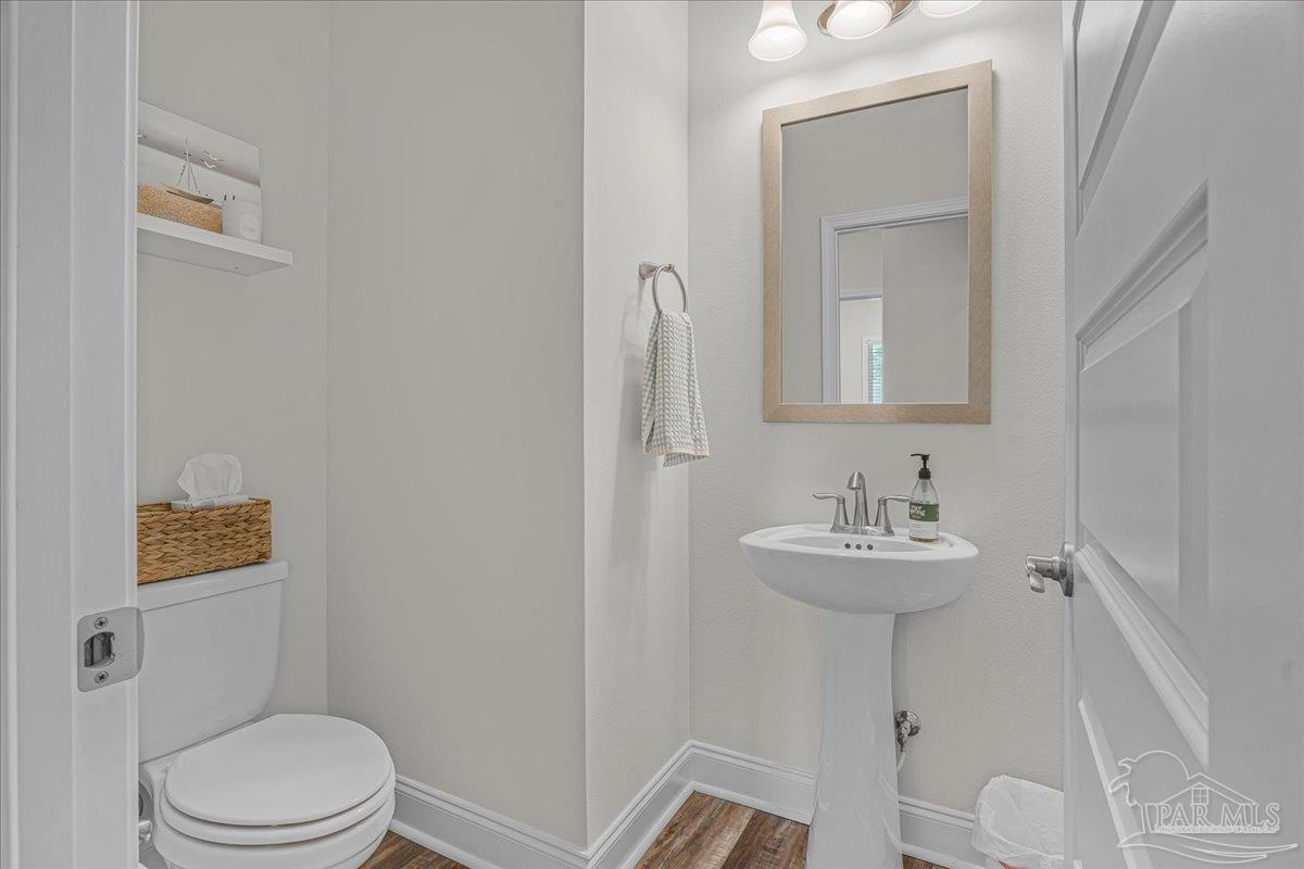 441 Broadleaf Circle Cantonment, FL 32533 - Photo 32 of 42 a bathroom with a toilet a sink and mirror