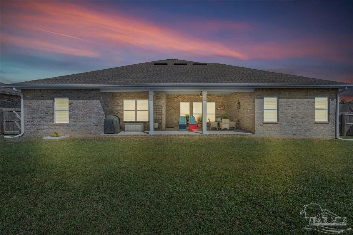 441 Broadleaf Circle Cantonment, FL 32533 - Photo 35 of 42 a front view of a house with a garden and yard