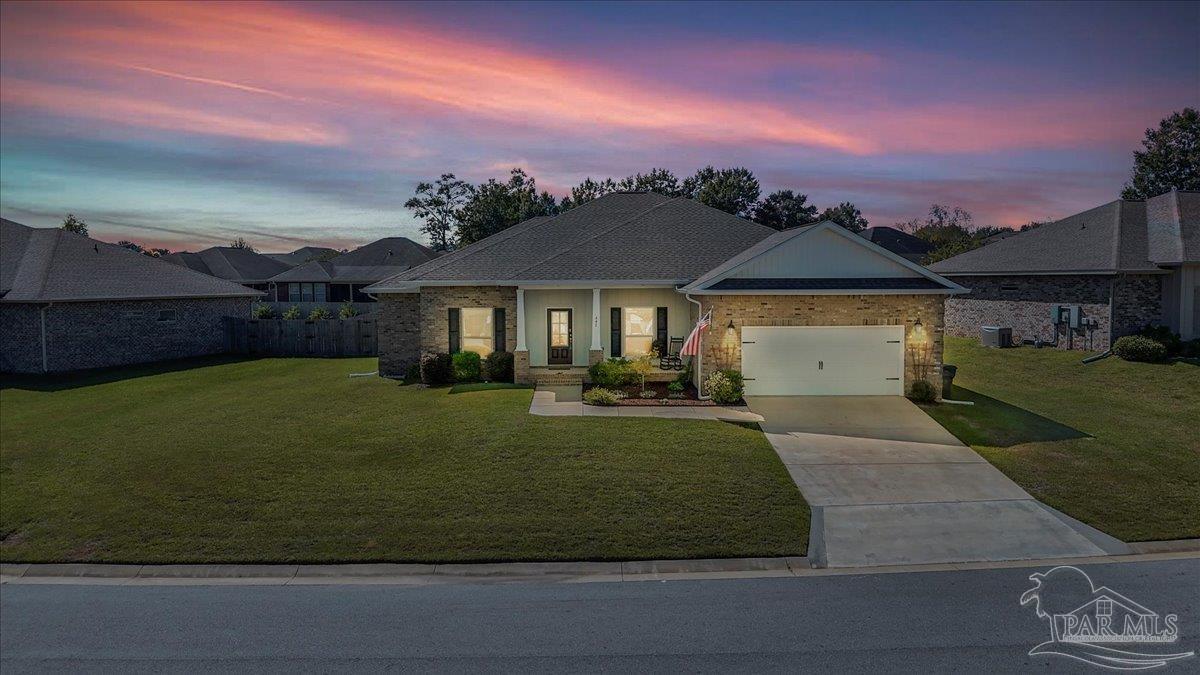 441 Broadleaf Circle Cantonment, FL 32533 - Photo 4 of 42 a front view of a house with a garden