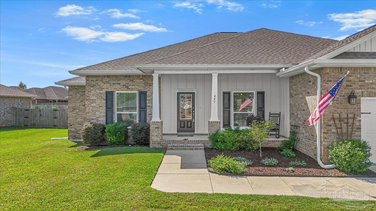 441 Broadleaf Circle Cantonment, FL 32533 - Photo 5 of 42 a front view of a house with garden