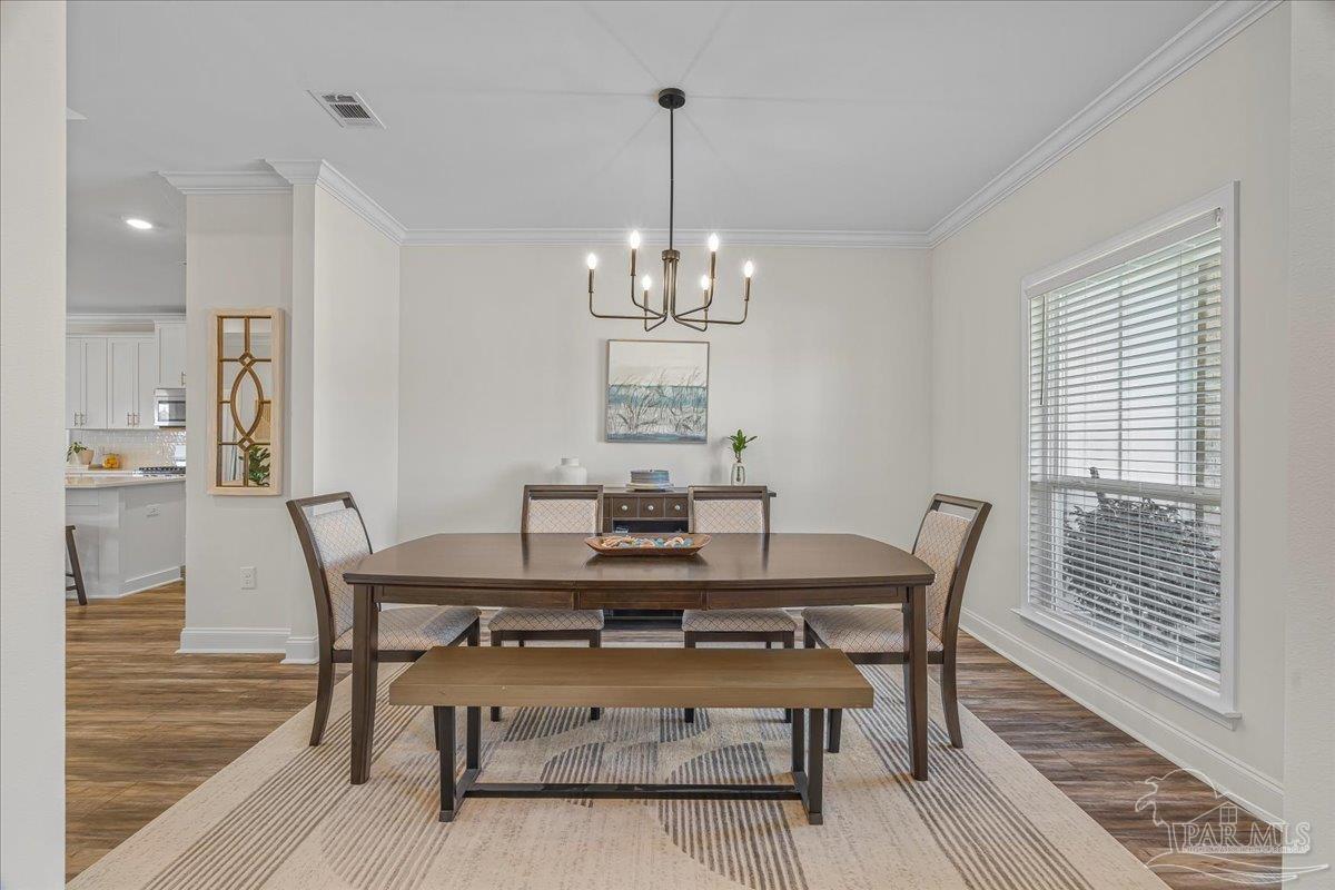 441 Broadleaf Circle Cantonment, FL 32533 - Photo 8 of 42 a view of a dining room with furniture window and wooden floor