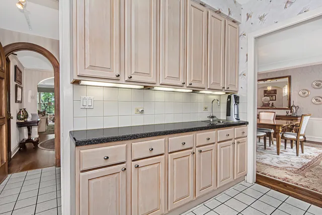 a kitchen with granite countertop a sink and cabinets