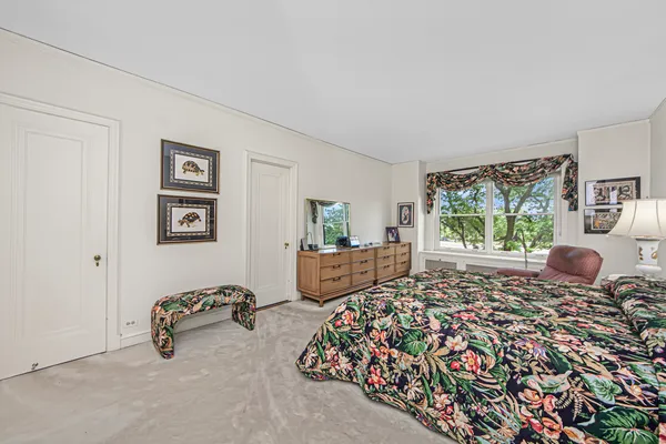 a living room with furniture and a book shelf