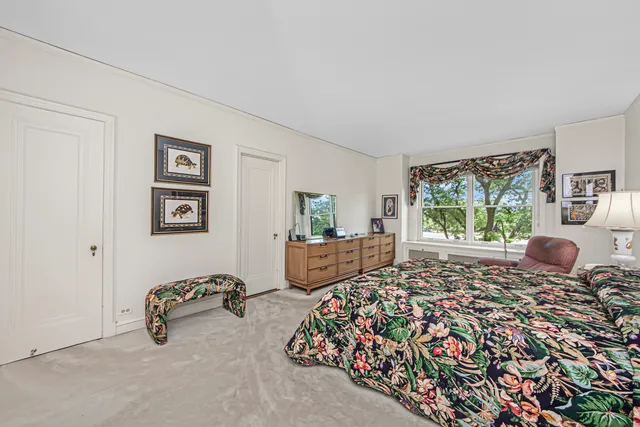 a living room with furniture and a book shelf