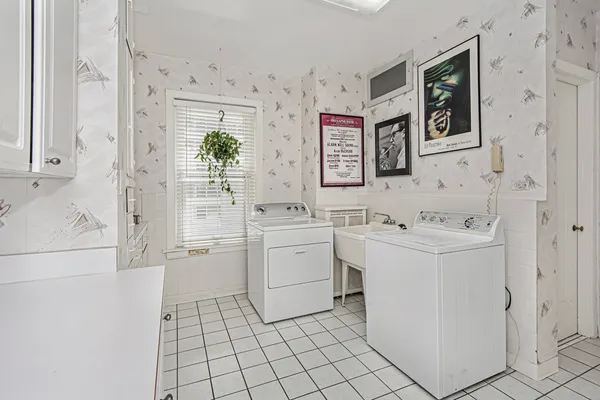 a kitchen with white cabinets and white appliances