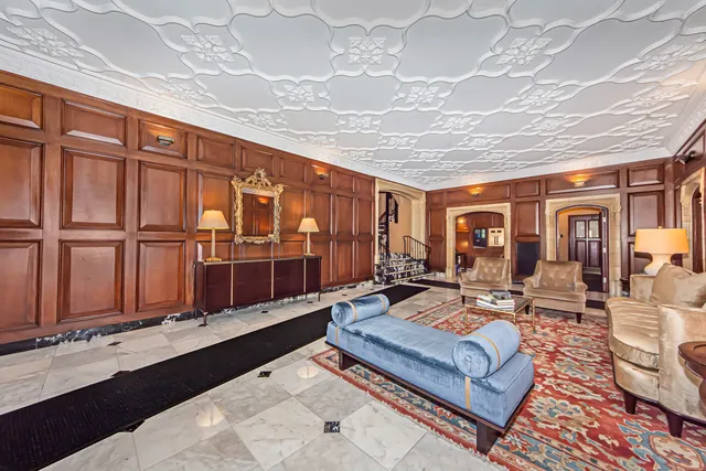 a living room with furniture a table and chairs