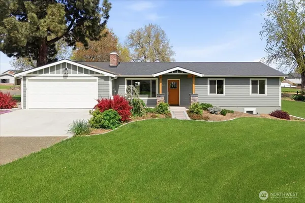 a front view of house with yard and green space