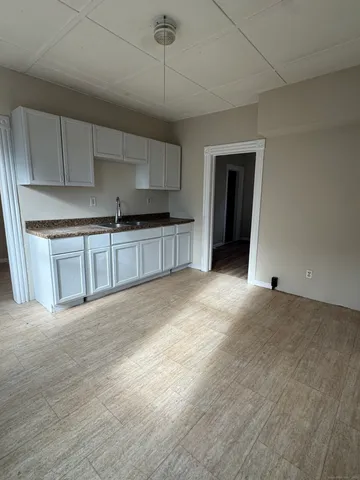 a large kitchen with stainless steel appliances granite countertop a stove a sink and a refrigerator