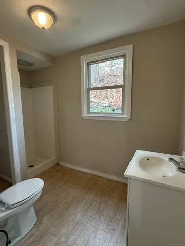 a bathroom with a toilet sink and vanity