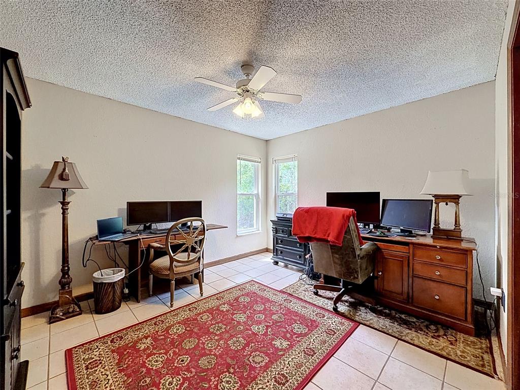 7111 Ricker Avenue Webster, FL 33597 - Photo 27 of 41 a living room with furniture and a flat screen tv