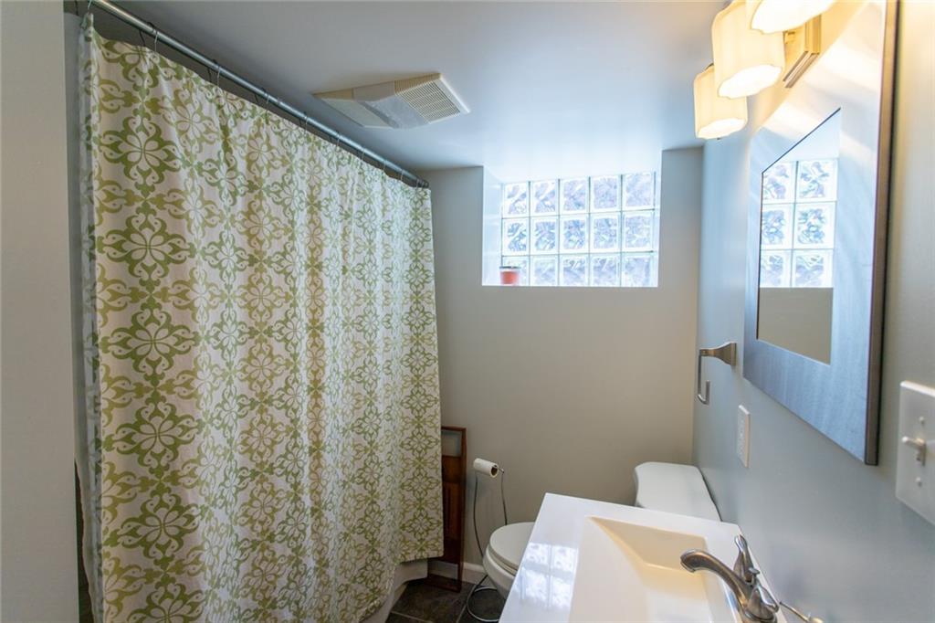 3211 Willett Road Pittsburgh, PA 15227 - Photo 19 of 27 a bathroom with a toilet and a shower curtain
