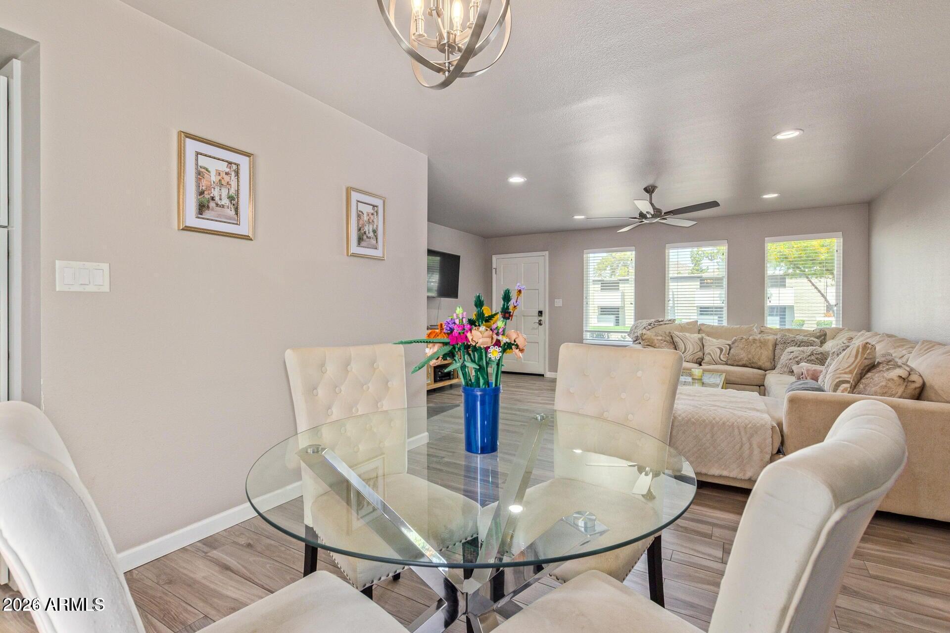 5913 East Thomas Road Scottsdale, AZ 85251 - Photo 12 of 26 a living room with furniture and a dining table with wooden floor