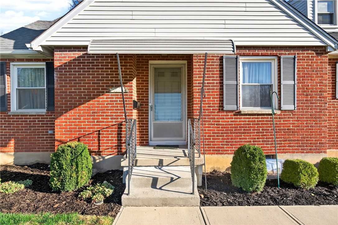 1237 Laurelwood Road Dayton, OH 45409 - Photo 4 of 56 Brick facade with classic shutters and a welcoming front entrance.