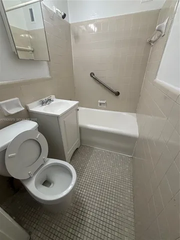 a bathroom with a toilet a sink and bathtub