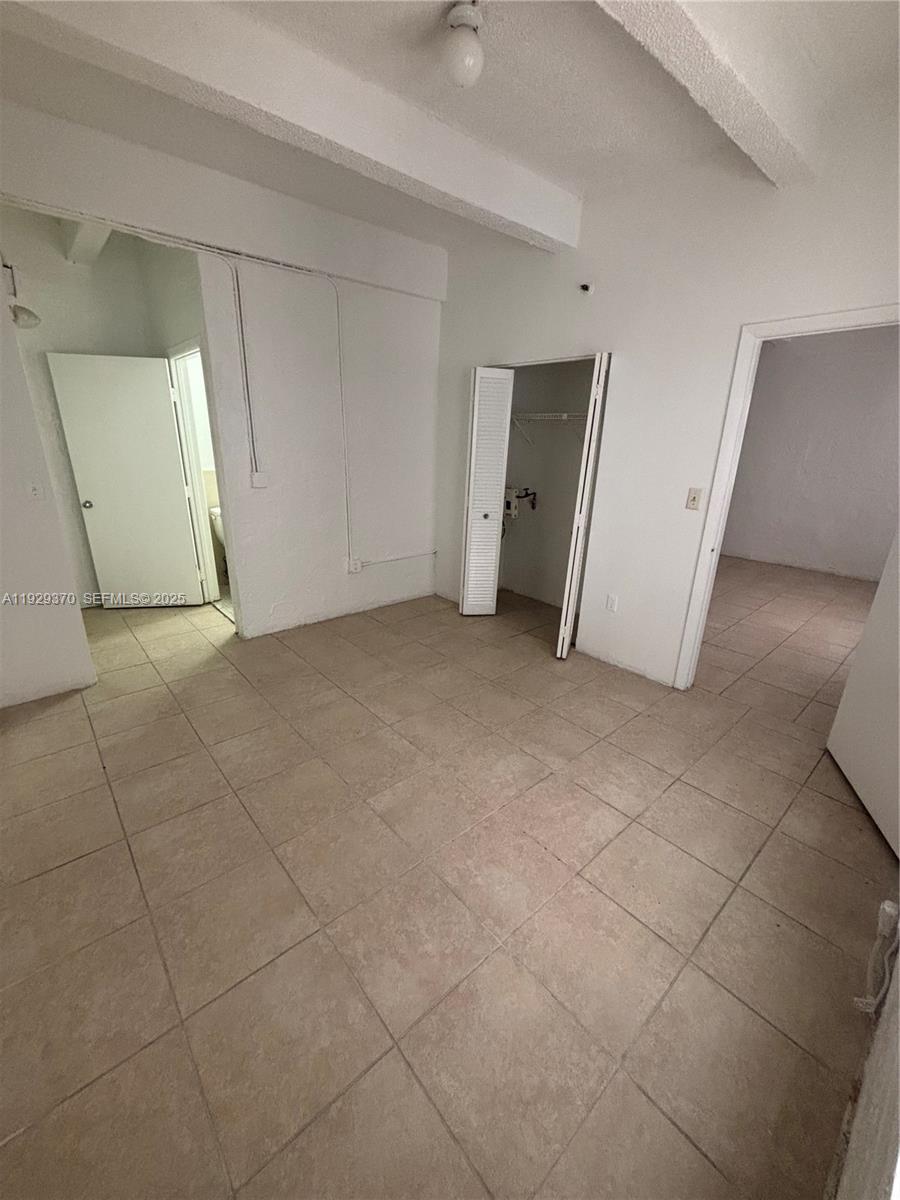 220 23rd Street, Unit 303 Miami Beach, FL 33139 - Photo 4 of 5 an empty room with a bathroom