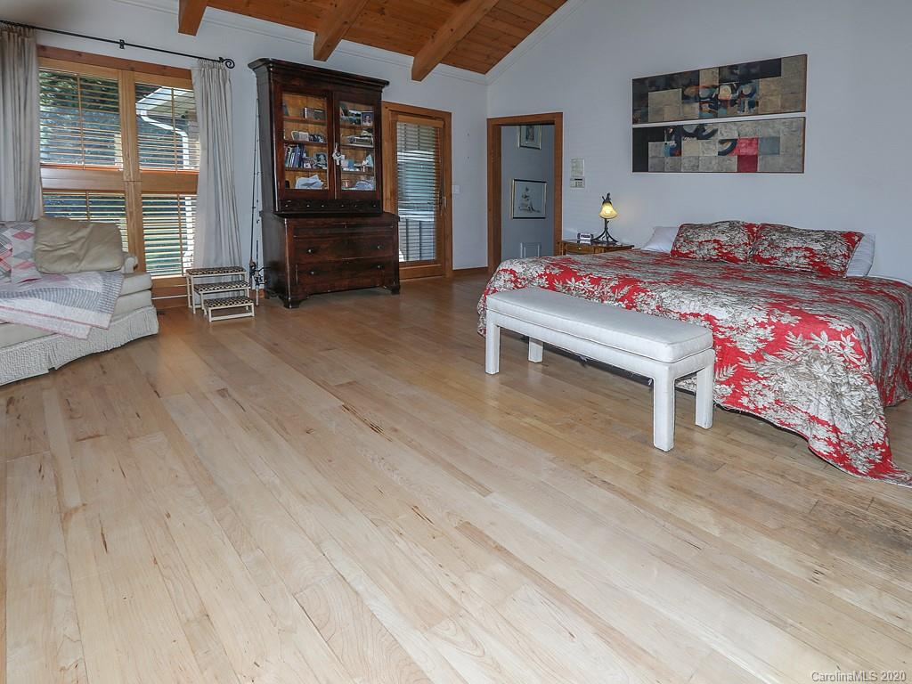 950 Walker Road Waynesville, NC 28786 - Photo 13 of 29 a bedroom with a bed and wooden floor