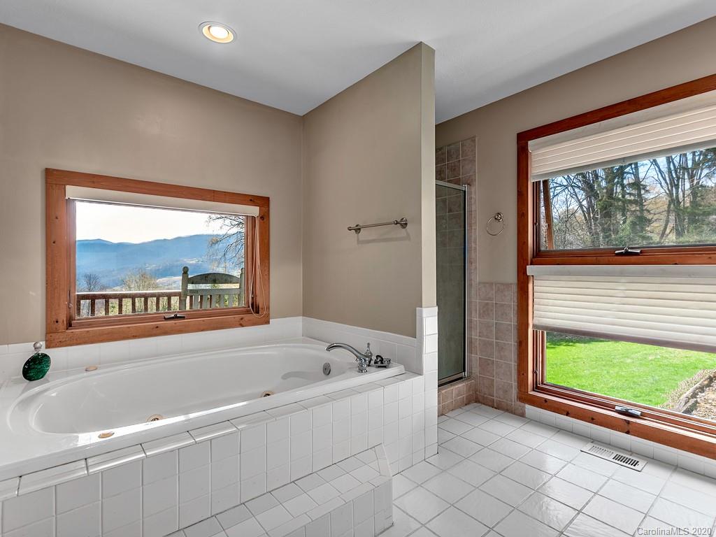 950 Walker Road Waynesville, NC 28786 - Photo 15 of 29 a white bath tub sitting next to a window