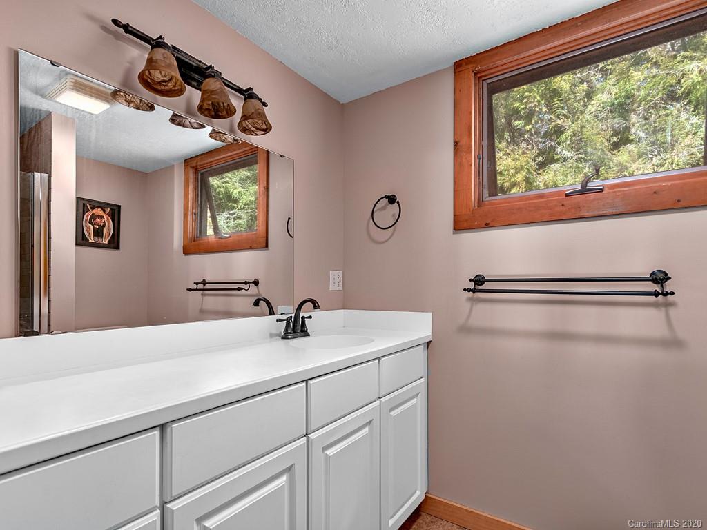 950 Walker Road Waynesville, NC 28786 - Photo 17 of 29 a bathroom with a sink and a mirror