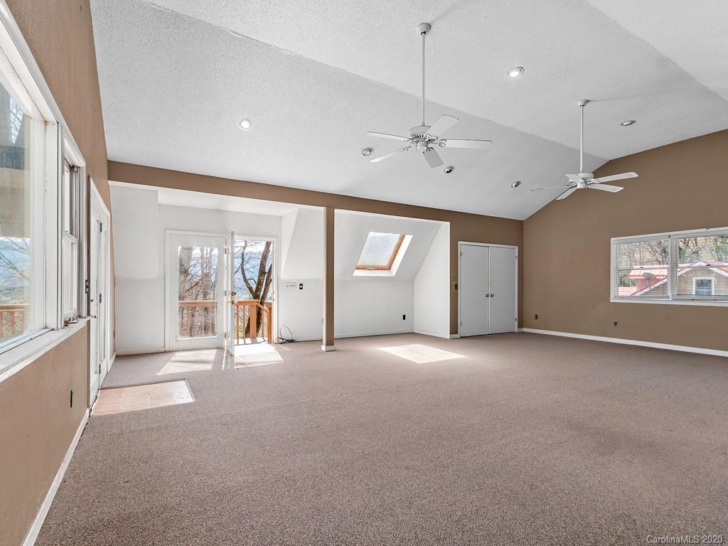 950 Walker Road Waynesville, NC 28786 - Photo 20 of 29 a view of a livingroom with an empty space and a window