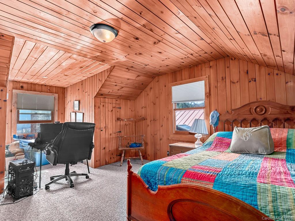 950 Walker Road Waynesville, NC 28786 - Photo 22 of 29 a bedroom with a bed and a chair