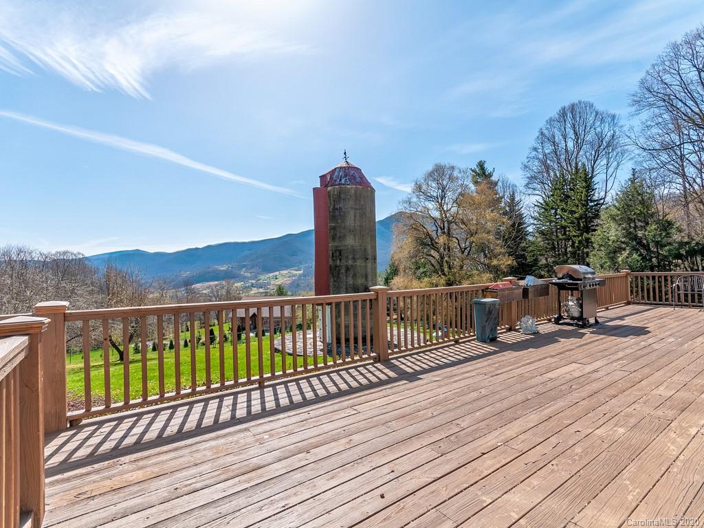 950 Walker Road Waynesville, NC 28786 - Photo 24 of 29 a view of roof deck with wooden floor and fence with a bench