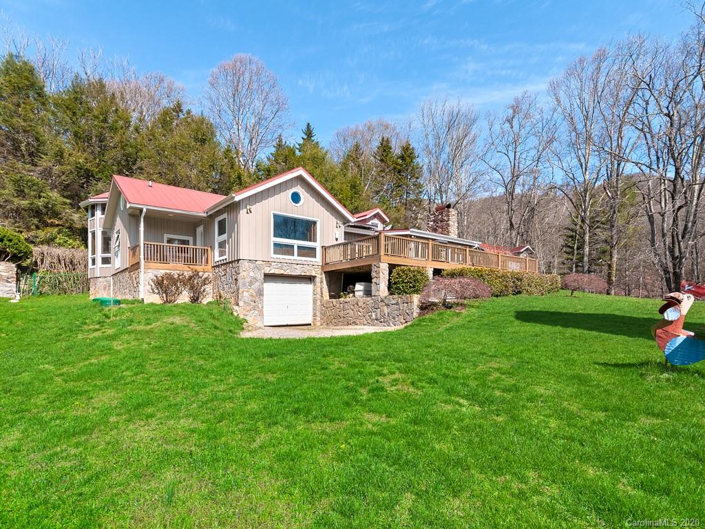 950 Walker Road Waynesville, NC 28786 - Photo 27 of 29 a front view of a house with a yard table and chairs