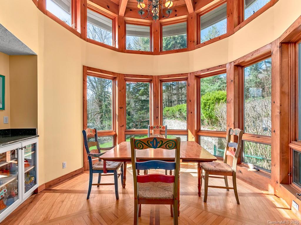 950 Walker Road Waynesville, NC 28786 - Photo 9 of 29 a view of a dining room with furniture window and wooden floor