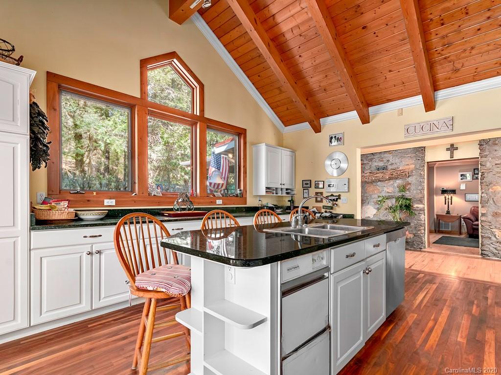 950 Walker Road Waynesville, NC 28786 - Photo 10 of 29 a kitchen with a sink and chairs