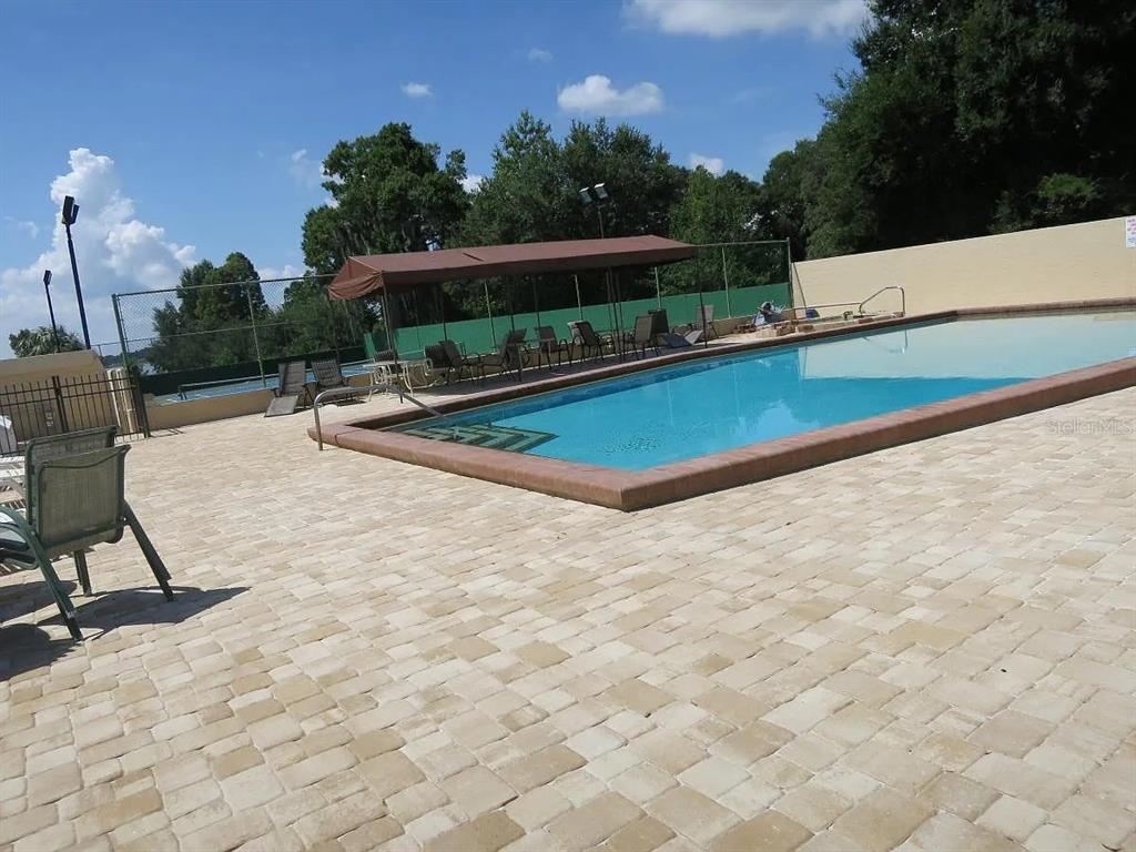 17 Casarena Court Winter Haven, FL 33881 - Photo 11 of 13 a view of a swimming pool with a lounge chair