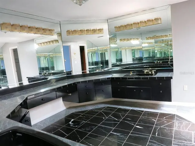 a kitchen with a large stove a sink and cabinets