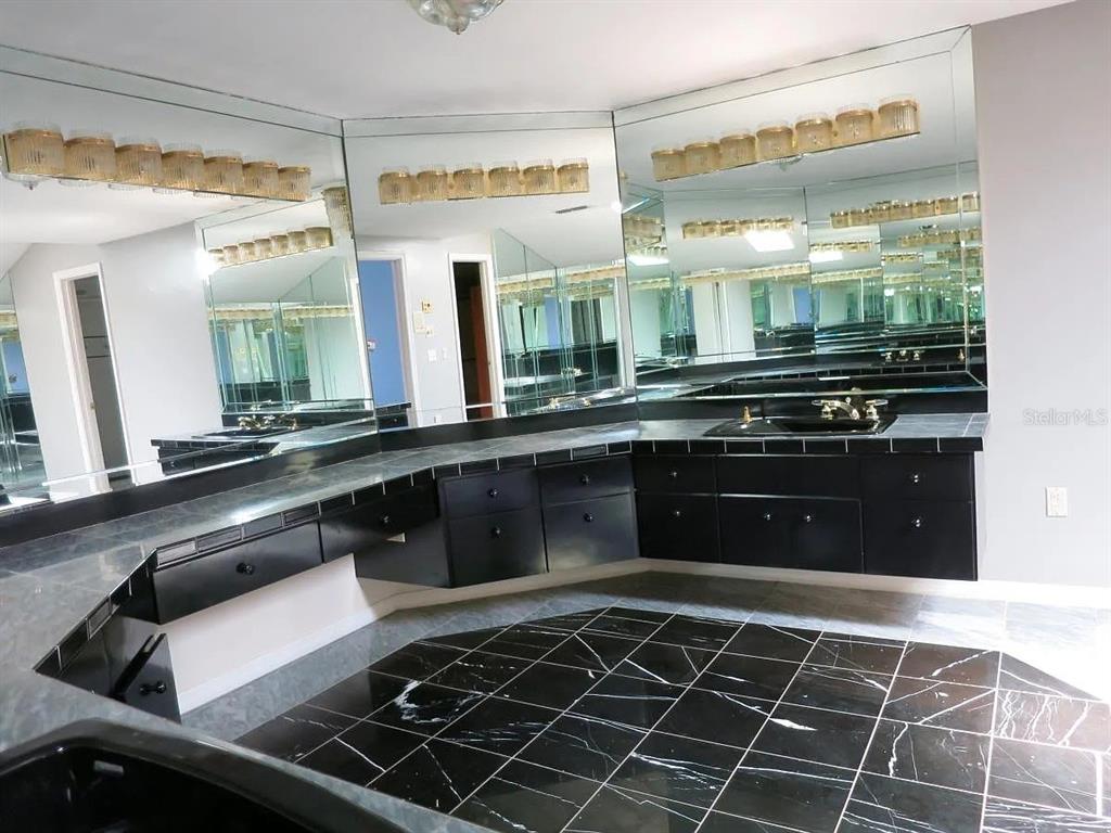 17 Casarena Court Winter Haven, FL 33881 - Photo 4 of 13 a kitchen with a large stove a sink and cabinets