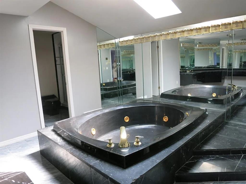 17 Casarena Court Winter Haven, FL 33881 - Photo 5 of 13 a living room with stainless steel appliances granite countertop a sink a stove and a wooden floors