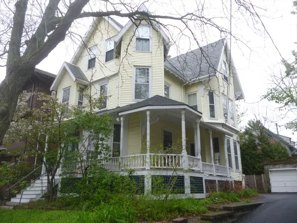 a front view of residential houses with yard and green space